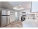 Modern kitchen with stainless steel appliances, white cabinets, and bright lighting at 701 W Idlewild Ave, Tampa, FL 33604