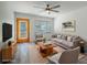 Staged living room with wood floors, modern furniture, ceiling fan, and bright natural light at 701 W Idlewild Ave, Tampa, FL 33604
