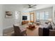 Bright living room featuring wood flooring, a ceiling fan and a decorative front door at 701 W Idlewild Ave, Tampa, FL 33604