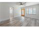 Bright living room with wood flooring, ceiling fan, and a view of the entry door at 701 W Idlewild Ave, Tampa, FL 33604