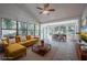 Bright staged sunroom featuring numerous windows, tile floors, ceiling fan at 701 W Idlewild Ave, Tampa, FL 33604
