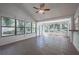 Bright sunroom featuring numerous windows, tile floors, and ceiling fan at 701 W Idlewild Ave, Tampa, FL 33604