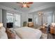 Stylishly furnished bedroom featuring a ceiling fan, light colors and wood flooring at 701 W Idlewild Ave, Tampa, FL 33604