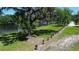 Scenic view of property's water access with mature trees, a grassy lawn, and a path at 701 W Idlewild Ave, Tampa, FL 33604