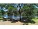 Picturesque waterfront view with mature trees creating a serene and inviting atmosphere at 701 W Idlewild Ave, Tampa, FL 33604