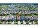 Aerial view of a residential community featuring lush landscaping, a lake, and convenient street access at 7417 Sungold Meadow Ct, Apollo Beach, FL 33572