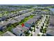 Aerial view of homes in a beautiful community showcasing their lush lawns, mature trees and proximity to a lake at 7417 Sungold Meadow Ct, Apollo Beach, FL 33572