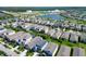 An aerial view of a residential community, featuring lush landscaping, well-maintained homes, and a scenic lake at 7417 Sungold Meadow Ct, Apollo Beach, FL 33572