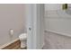 Bathroom featuring a toilet and a glimpse into the walk-in closet with carpet and wire shelving at 7417 Sungold Meadow Ct, Apollo Beach, FL 33572