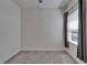 Empty bedroom with carpet flooring, a window with curtains, and neutral wall paint at 7417 Sungold Meadow Ct, Apollo Beach, FL 33572