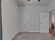 This carpeted bedroom features neutral walls and two doors for easy access and convenience at 7417 Sungold Meadow Ct, Apollo Beach, FL 33572