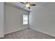 Neutral carpeted bedroom featuring a bright ceiling fan and window with adjustable blinds at 7417 Sungold Meadow Ct, Apollo Beach, FL 33572