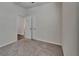 Nicely carpeted bedroom with neutral walls, ceiling fan and a doorway to another room at 7417 Sungold Meadow Ct, Apollo Beach, FL 33572