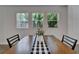 Dining area features a dark wood table with a black and white runner and views of palm trees at 7417 Sungold Meadow Ct, Apollo Beach, FL 33572