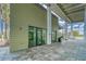 Modern fitness center with ample natural light, exercise equipment, and a welcoming patio area at 7417 Sungold Meadow Ct, Apollo Beach, FL 33572