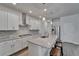 Stylish kitchen with stainless steel appliances, granite countertops, mosaic backsplash, and a large island at 7417 Sungold Meadow Ct, Apollo Beach, FL 33572
