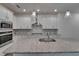 Gourmet kitchen with granite countertops, stainless appliances, mosaic backsplash, recessed lighting, and kitchen island at 7417 Sungold Meadow Ct, Apollo Beach, FL 33572