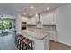 Modern kitchen with stainless steel appliances, white cabinets, granite countertops, and a center island at 7417 Sungold Meadow Ct, Apollo Beach, FL 33572