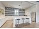 Bright kitchen with white cabinets, an island with seating, and a stylish backsplash at 7417 Sungold Meadow Ct, Apollo Beach, FL 33572