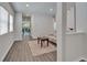 Hallway view of the living room with modern floors, leading to the dining area and backyard at 7417 Sungold Meadow Ct, Apollo Beach, FL 33572