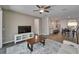 Open concept living room with views of the kitchen and dining area, featuring modern floors at 7417 Sungold Meadow Ct, Apollo Beach, FL 33572