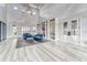 Bright and open lounge featuring high ceilings, modern finishes, and comfortable blue seating at 7417 Sungold Meadow Ct, Apollo Beach, FL 33572
