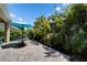 Relax in the sun on this brick patio with comfortable seating and a lush tropical backdrop at 7417 Sungold Meadow Ct, Apollo Beach, FL 33572