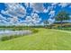 Enjoy picturesque pond views from lush green landscaping, perfect for relaxation at 7417 Sungold Meadow Ct, Apollo Beach, FL 33572