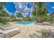 Relaxing poolside lounge area with comfortable seating and lush tropical landscaping at 7417 Sungold Meadow Ct, Apollo Beach, FL 33572