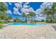 Large pool area with a waterslide and various seating options around the pool at 7417 Sungold Meadow Ct, Apollo Beach, FL 33572
