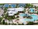 Aerial view of the community pool with slide, umbrellas, landscaping, and clubhouse at 7417 Sungold Meadow Ct, Apollo Beach, FL 33572
