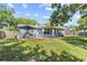 Charming backyard featuring a patio with seating, surrounded by lush landscaping at 7747 90Th N Way, Seminole, FL 33777