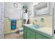 Vintage bathroom design with aqua tile and pastel yellow walls and large mirror at 7747 90Th N Way, Seminole, FL 33777