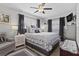 This primary bedroom has hardwood floors, dual windows, a ceiling fan, and a gray accent wall at 7747 90Th N Way, Seminole, FL 33777