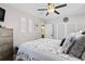 Light and airy bedroom with white walls, a ceiling fan, and a decorative accent wall at 7747 90Th N Way, Seminole, FL 33777