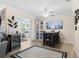 Bright dining area adjacent to the living room with a ceiling fan and views into other rooms at 7747 90Th N Way, Seminole, FL 33777