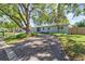 Long driveway leading to a charming single-story home with a well-manicured front yard at 7747 90Th N Way, Seminole, FL 33777