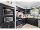 Kitchen boasts stainless steel appliances, butcher block countertops, and ample cabinet space at 7747 90Th N Way, Seminole, FL 33777