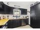 The kitchen features black cabinets, butcher block countertops, stainless steel appliances, and recessed lighting at 7747 90Th N Way, Seminole, FL 33777