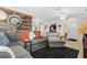 Open living space with a large sectional, wood accent wall, and seamless flow to adjacent rooms at 7747 90Th N Way, Seminole, FL 33777