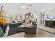 Spacious living room with a large sectional sofa, wood accent wall, and bright natural light at 7747 90Th N Way, Seminole, FL 33777