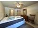 Cozy bedroom featuring a ceiling fan, dresser, and ample closet space at 7939 Pine Dr # 7939, Temple Terrace, FL 33637