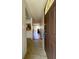 Hallway leading to living area with tile flooring and natural light at 7939 Pine Dr # 7939, Temple Terrace, FL 33637