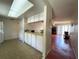 Bright kitchen with white cabinets, skylight, and open layout at 7939 Pine Dr # 7939, Temple Terrace, FL 33637