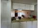 Eat-in kitchen with a view into the living room area and dining space with sliding glass doors at 7939 Pine Dr # 7939, Temple Terrace, FL 33637