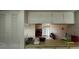 Eat-in kitchen with a view into the living room area and dining space with sliding glass doors at 7939 Pine Dr # 7939, Temple Terrace, FL 33637