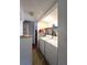 Well-lit laundry room equipped with a washer, dryer, and storage shelving at 7939 Pine Dr # 7939, Temple Terrace, FL 33637