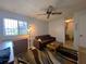 Living room with a brown sofa, dresser, and large window offering natural light at 7939 Pine Dr # 7939, Temple Terrace, FL 33637
