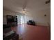 Living room featuring ceiling fan, entertainment center and sliding glass door at 7939 Pine Dr # 7939, Temple Terrace, FL 33637