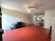 Open living room with ceiling fan and view into dining and kitchen areas at 7939 Pine Dr # 7939, Temple Terrace, FL 33637